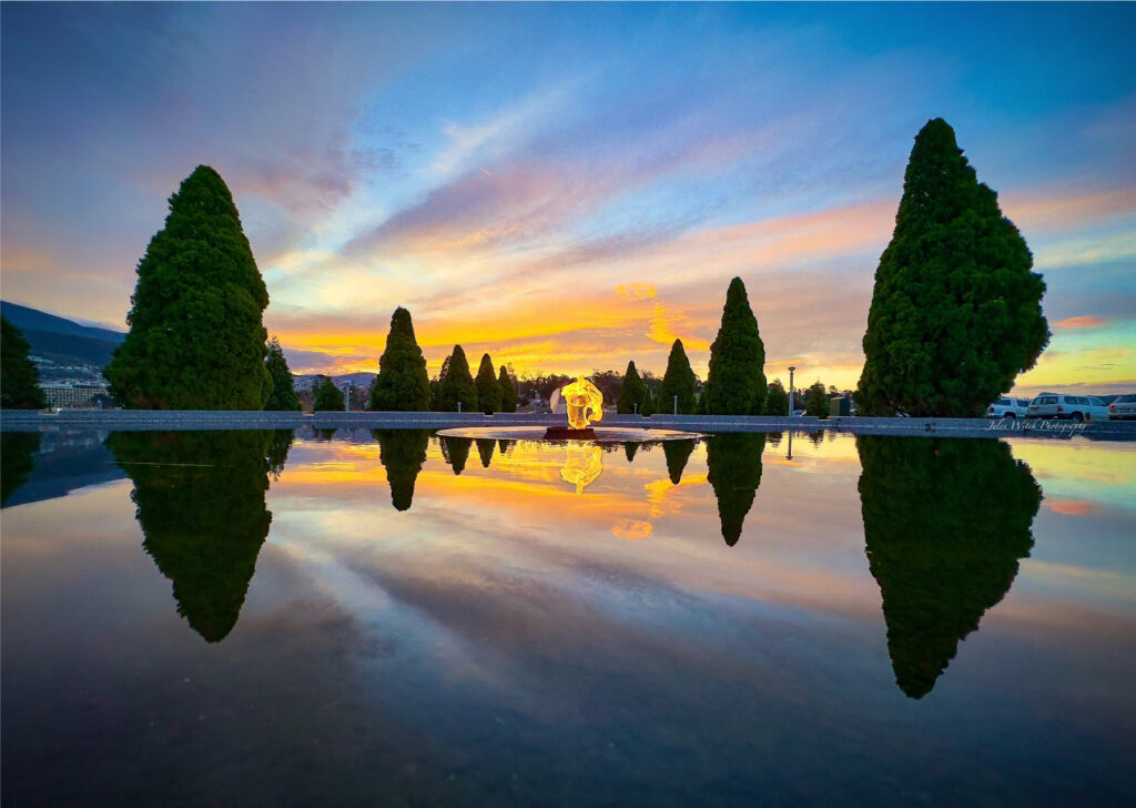 The Pool of Reflection and The Flame of Remembrance. Sunset on the Hobart Cenotaph. Image Credit: Jules Witek.